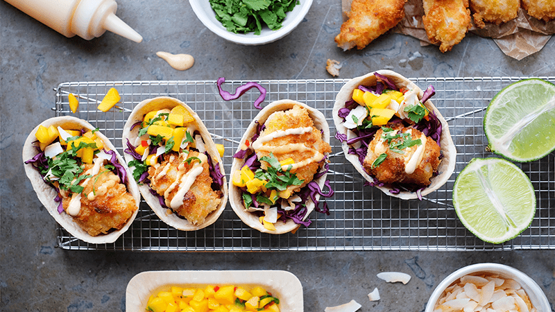Panko-friteeratut kalatacot hot mayon, mangosalsan ja kookoshiutaleiden kera
